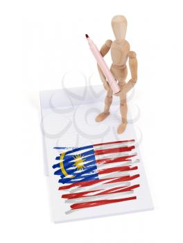 Wooden mannequin made a drawing of a flag - Malaysia