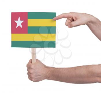Hand holding small card, isolated on white - Flag of Togo