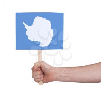 Hand holding small card, isolated on white - Flag of Antarctica