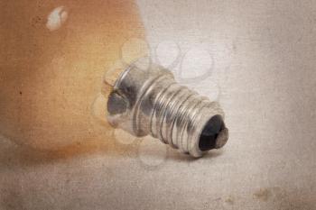 Old orange lightbulb isolated on a white background - Vintage look