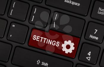 Red button Settings on black laptop keyboard