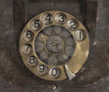 Closeup of vintage telephone dial, scratched and filthy