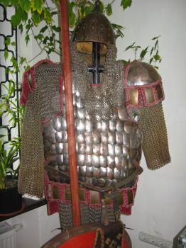 The image of ancient chain armour with a helmet