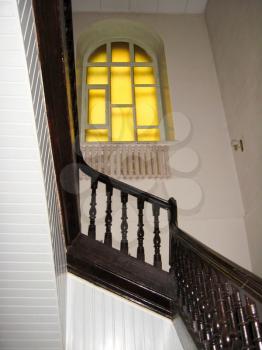 The image of nice wooden stairs with window