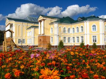 the image of building of beautiful school on a background of flowers