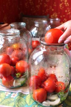 image of tomatos in jars prepared for preservation