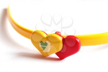 Pair of red and yellow hearts isolated on white background
