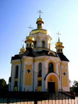 beautiful church with golden domes on a background of the blue sky