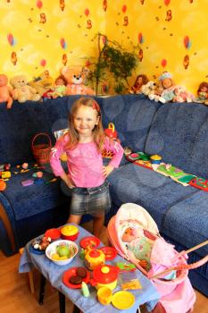 little girl playing with toys in her room