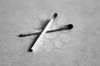 the black and white image of two burnt matches