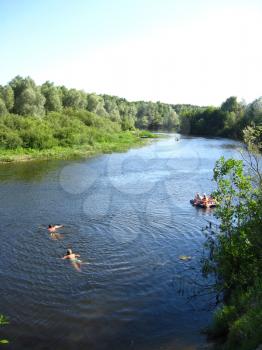 image of beautiful landscape with river, canoe and swimming people
