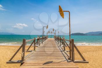 Wooden pier on city beach at Nha Trang, Vietnam in a summer day