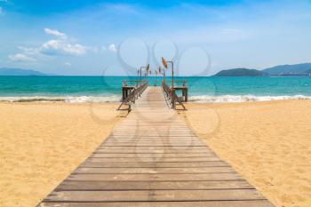 Wooden pier on city beach at Nha Trang, Vietnam in a summer day