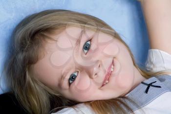 Portrait of cute toothless girl with blond hair