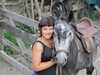 Portrait happy smiling woman with grey horse