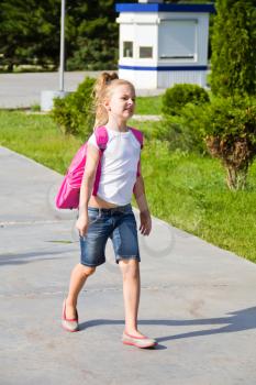 Cute girl go to school with pink knapsack