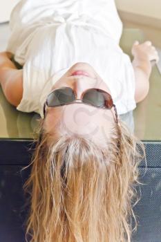 Photo of cute girl playing with sunglasses