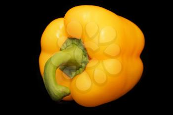 Image of yellow raw pepper on black background