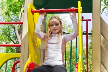 Photo of active girl on nursery platform in summer