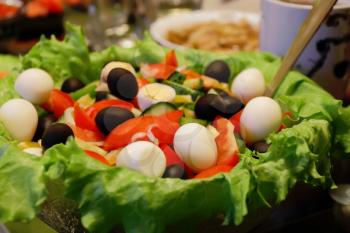 Image of colorful salad with black olives and eggs