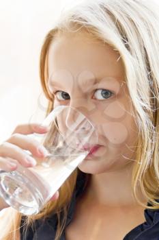 Portrait of Caucasian girl with white hair drinking water