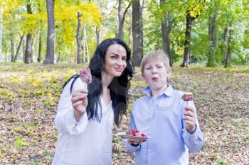 Photo of beautiful brunette and blond boy in autumn