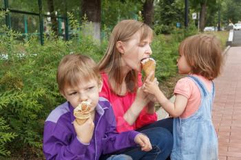 Nice family are eating icecream in summer