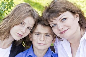 Portrait of happiest mother with daughter and son in summer time
