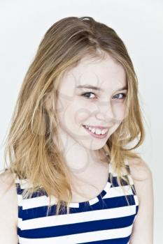 Cute girl eleven years old with blond long hair on white background