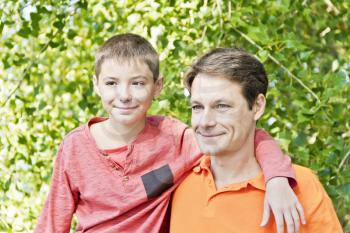 Portrait of father and son in summer time