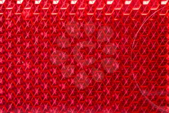 Red retro reflector macro texture. Abstract background.