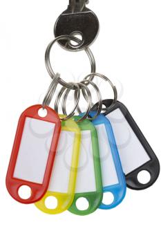 One key with five colorful tags isolated on white