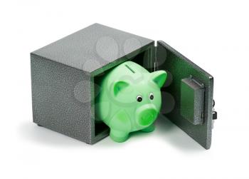 Green ceramic piggy bank in a safe, isolated on white background. Ecology investment, money for sustainable green energy, saving on costs, save the Earth concept.