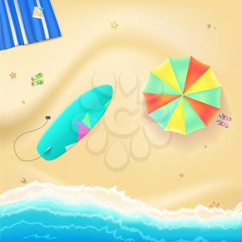Summer travel background. Sunny sandy beach with umbrella, mat, slippers and a surfboard. Tropical seashore with a view of the surf, top view.