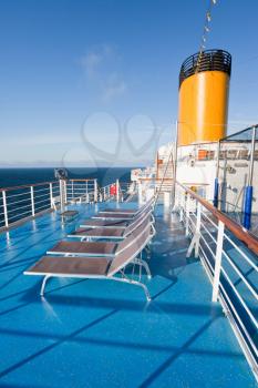 sunbath chairs on upper deck of cruise liner