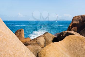 big boulders on Pink Granite Coast in Brittany in sunny day, France