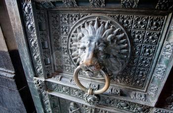 old bronze door handle in form of lion head in Aachen cathedral