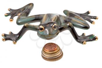 ceramic frog and coins isolated on white