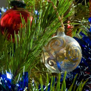 two glass balls and tinsel on Christmas-tree