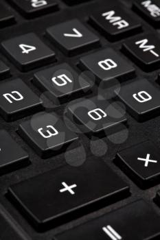 sum button on black calculator close-up