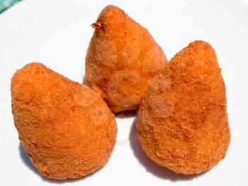 arancini - traditional sicilian fired rice fastfood on white plate outdoor