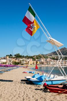 flags of Italy and Sicily under beach