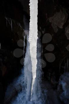 frozen stream in winter. icicle in cleft