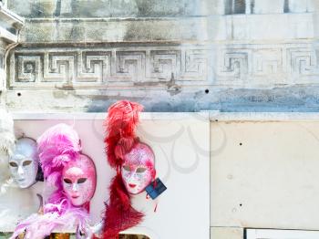 venetian carnival masks on old wall in Venice, Italy