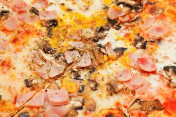 background from italian pizza with fungi and prosciutto cotto close up