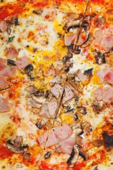 background from italian pizza with fungi and ham close up