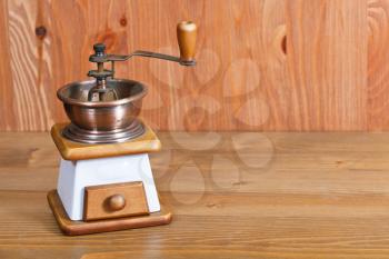 vintage manual coffee mill on wooden table