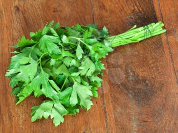 bunch of fresh green parsley on wooden table