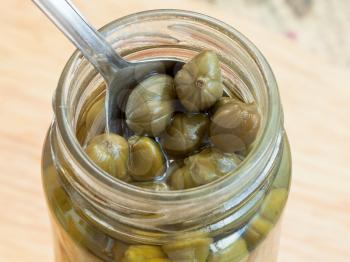 pickled capers in glass jar close up
