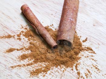 Cinnamon powder spice and bark sticks close up